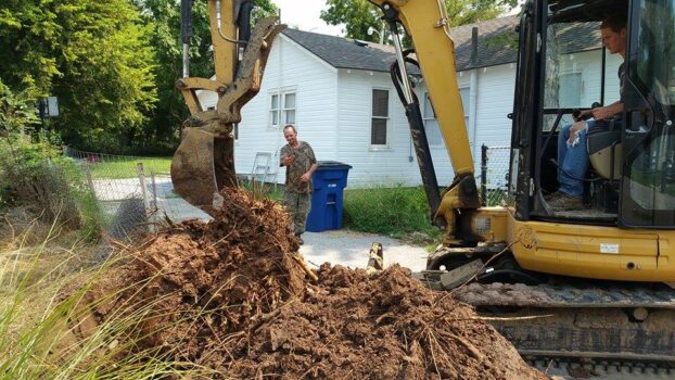 Man excavating a septic tank